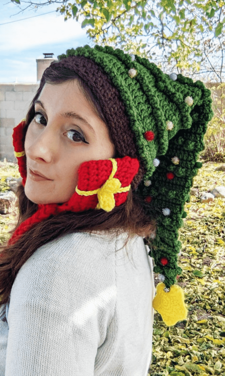 woman wearing christmas tree hat with christmas gift ear flaps