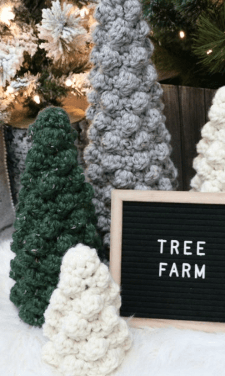 crochet christmas trees of various colors and sizes