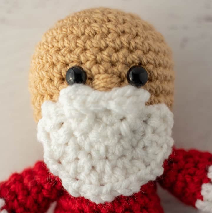 Crochet Santa in red suit, black boots.
