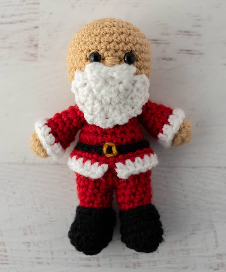 Crochet Santa in red suit, black boots.
