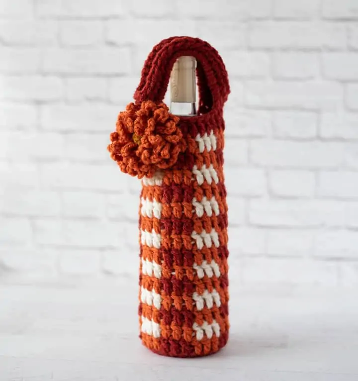Crochet Orange Plaid Wine Cozy with Orange Flower standing up