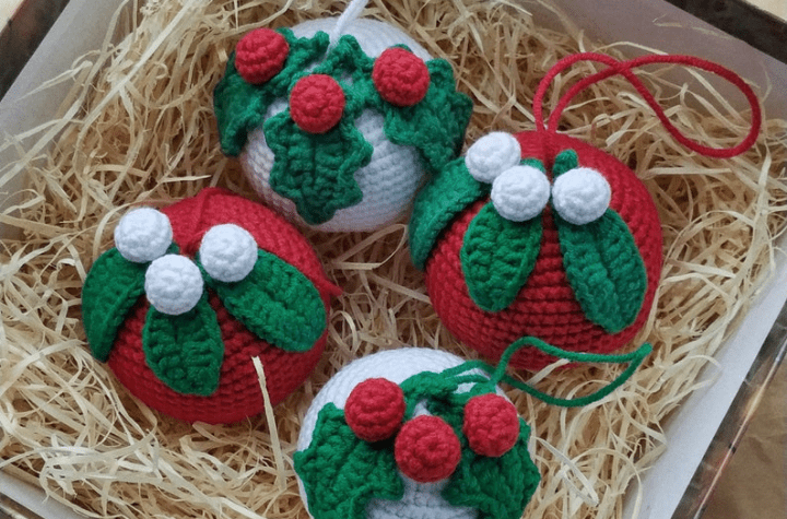 four holly sphere ornaments in a straw basket