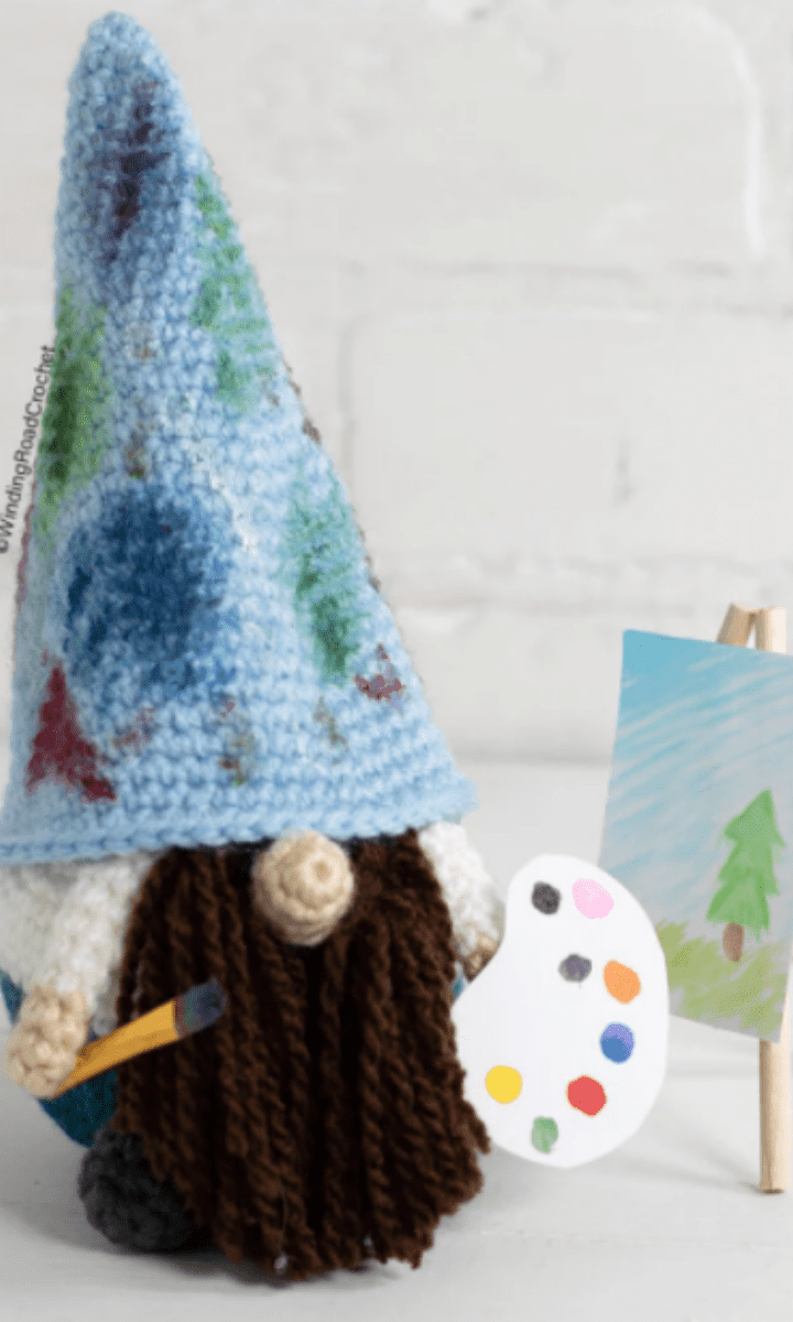 crochet painter gnome with canvas, paints, and paintbrush