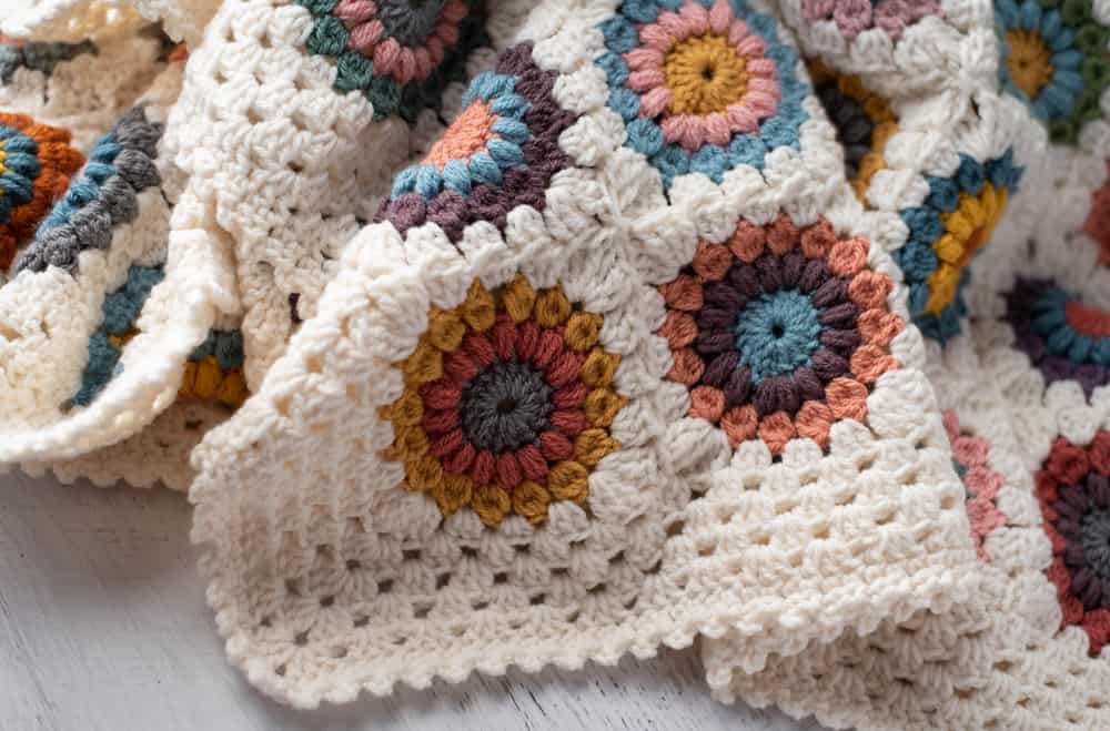 Crochet multi color afghan with ivory border