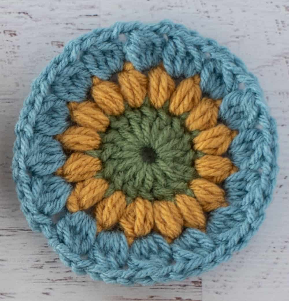 Crochet motif in green yellow and blue yarn