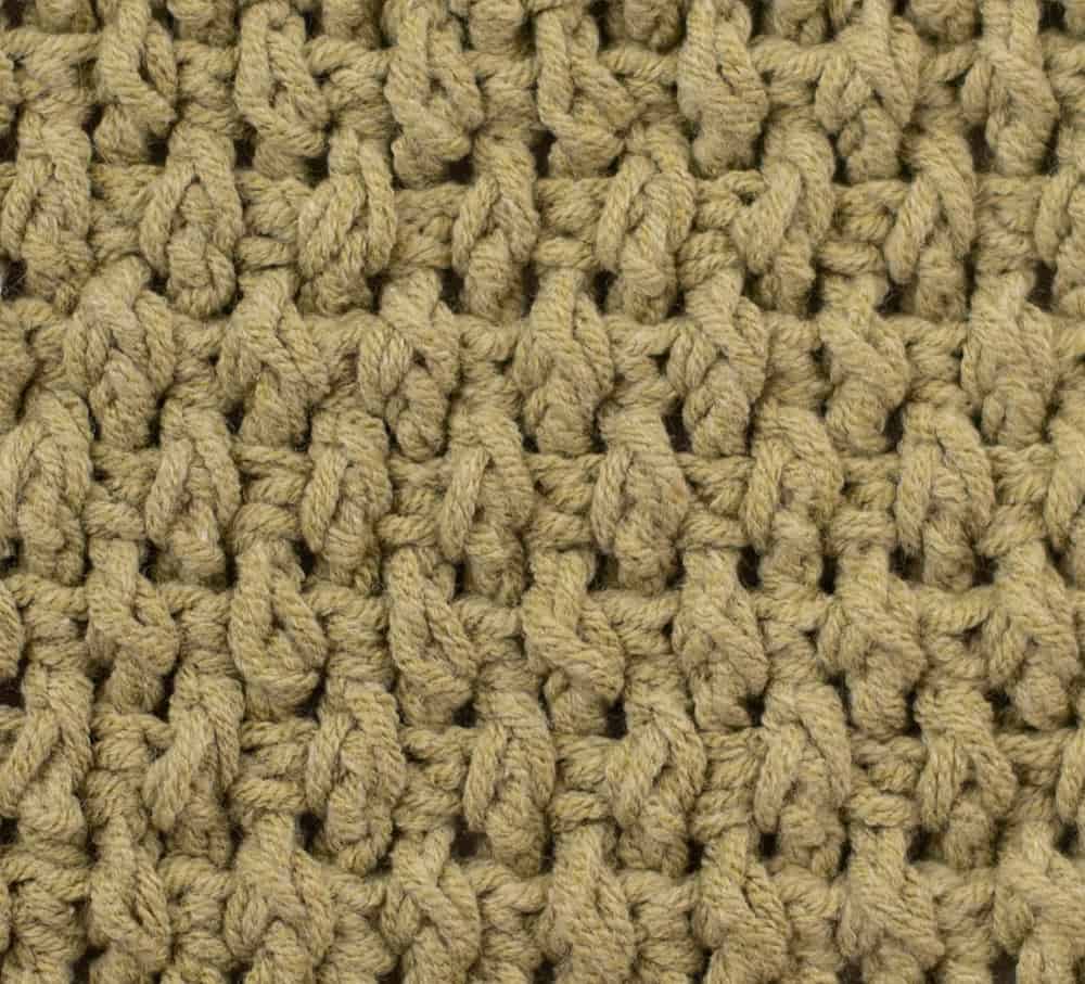 Crochet rice stitch close up in green yarn