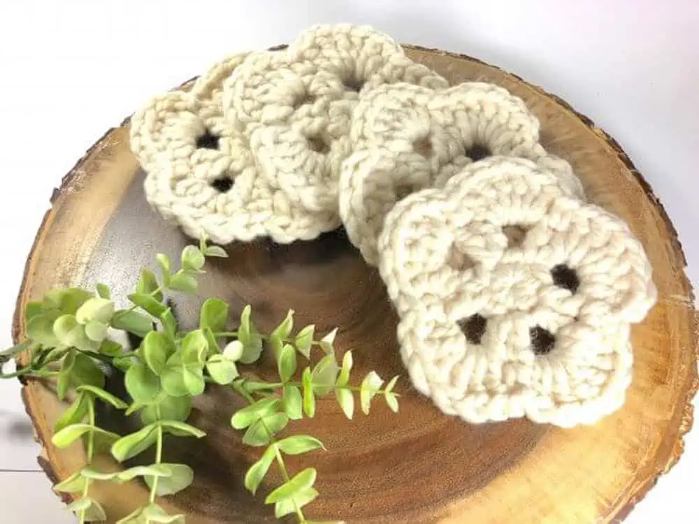 white crochet coasters on wood trivet