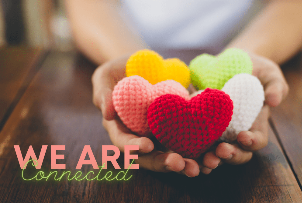 graphic of hands holding crochet hearts in multiple colors with words "we are connected"
