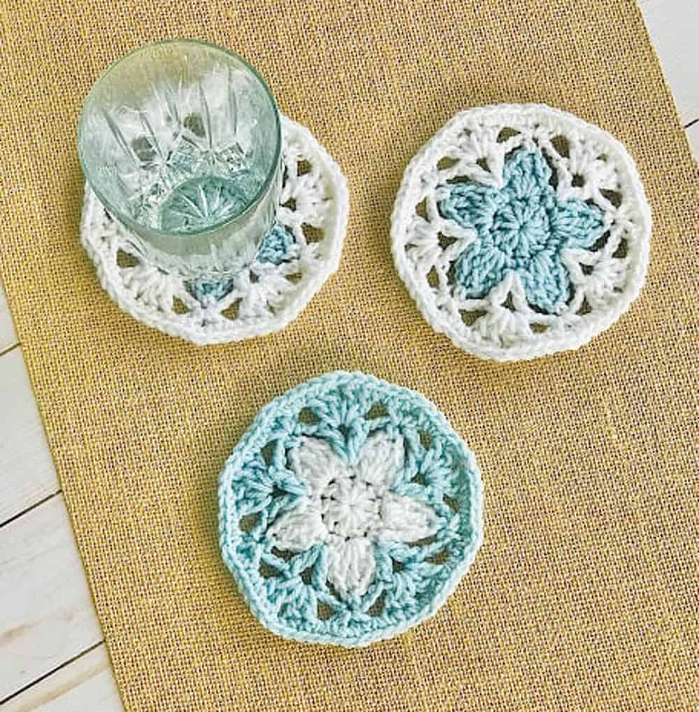 blue and white crochet coasters with glass