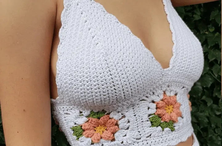 A white crochet bralette with granny square flowers around the middle.