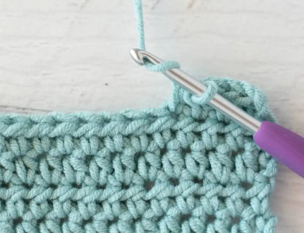 blue crochet half double crochet sample with silver and purple crochet hook