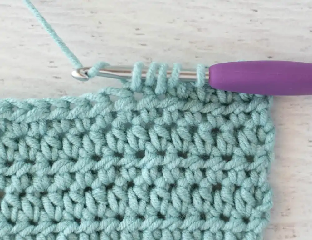 blue crochet half double crochet sample with silver and purple crochet hook