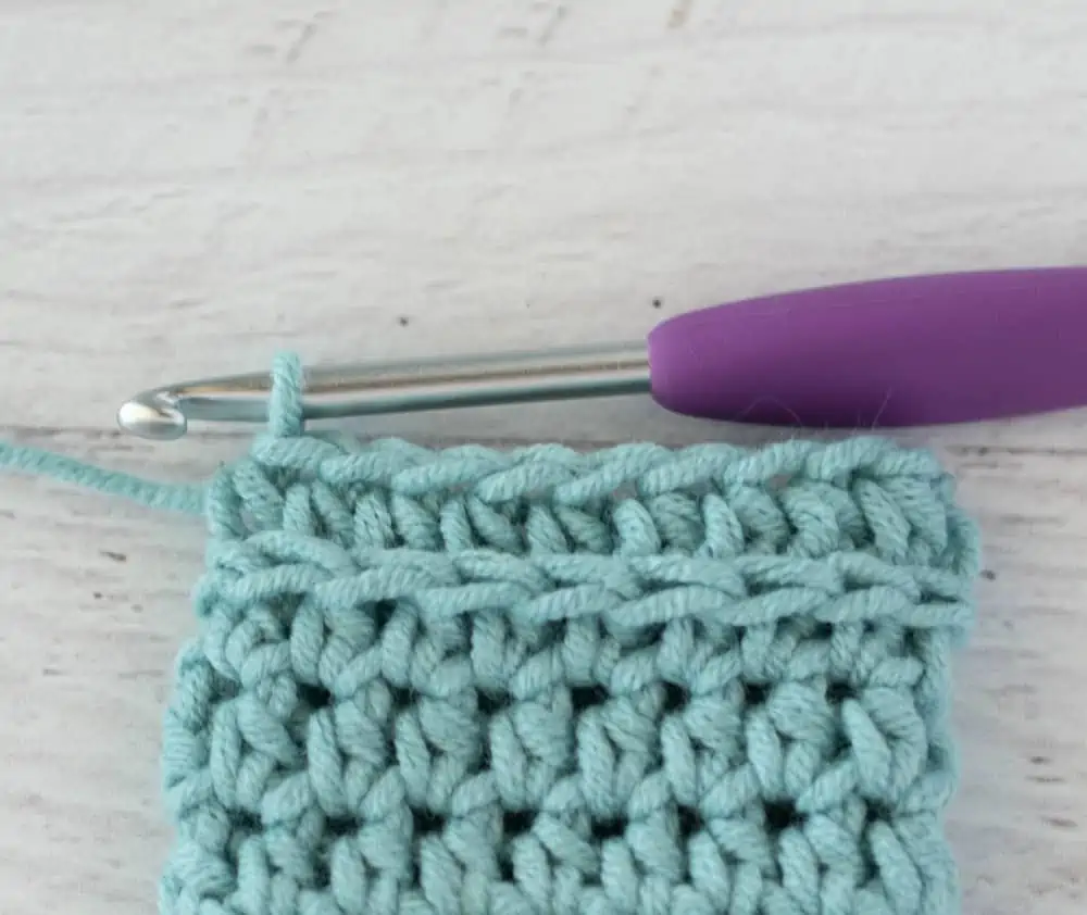 blue crochet half double crochet sample with silver and purple crochet hook