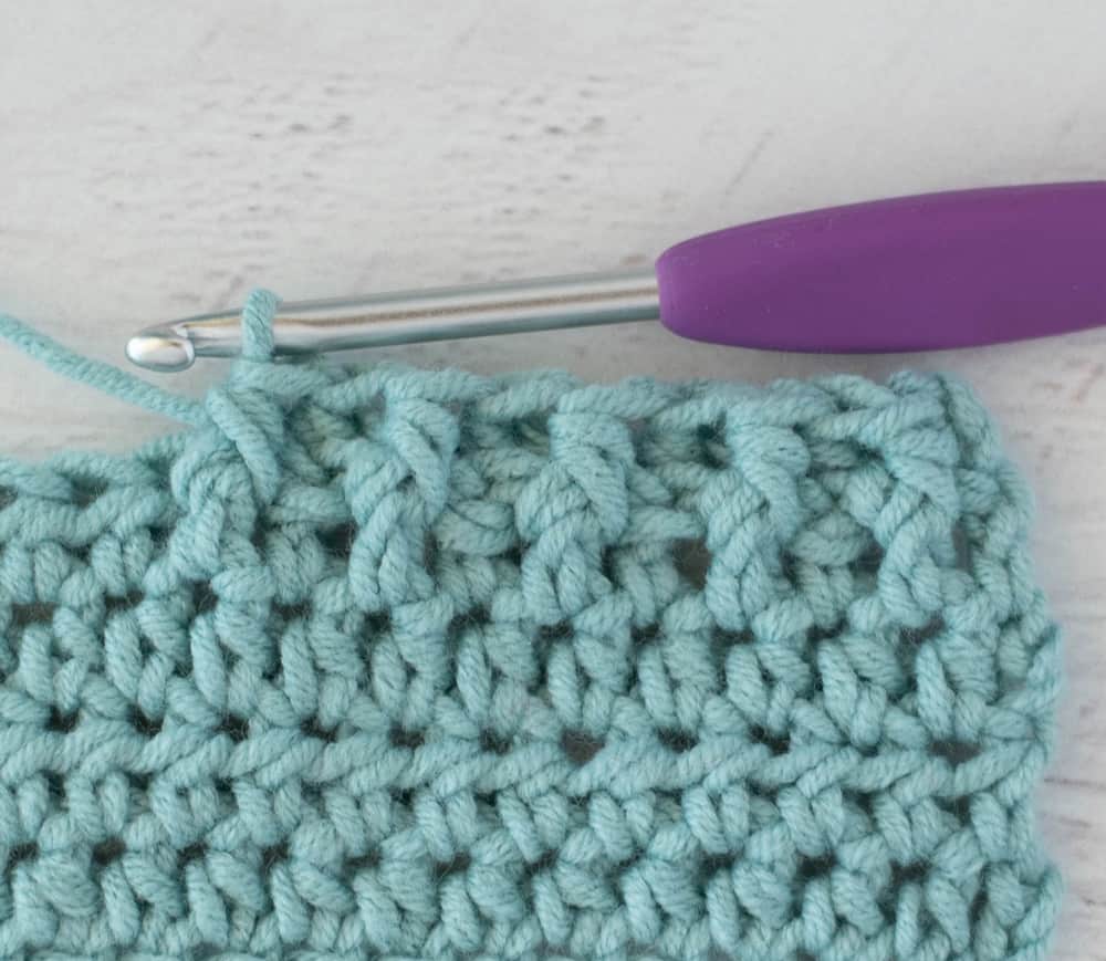 blue crochet half double crochet sample with silver and purple crochet hook