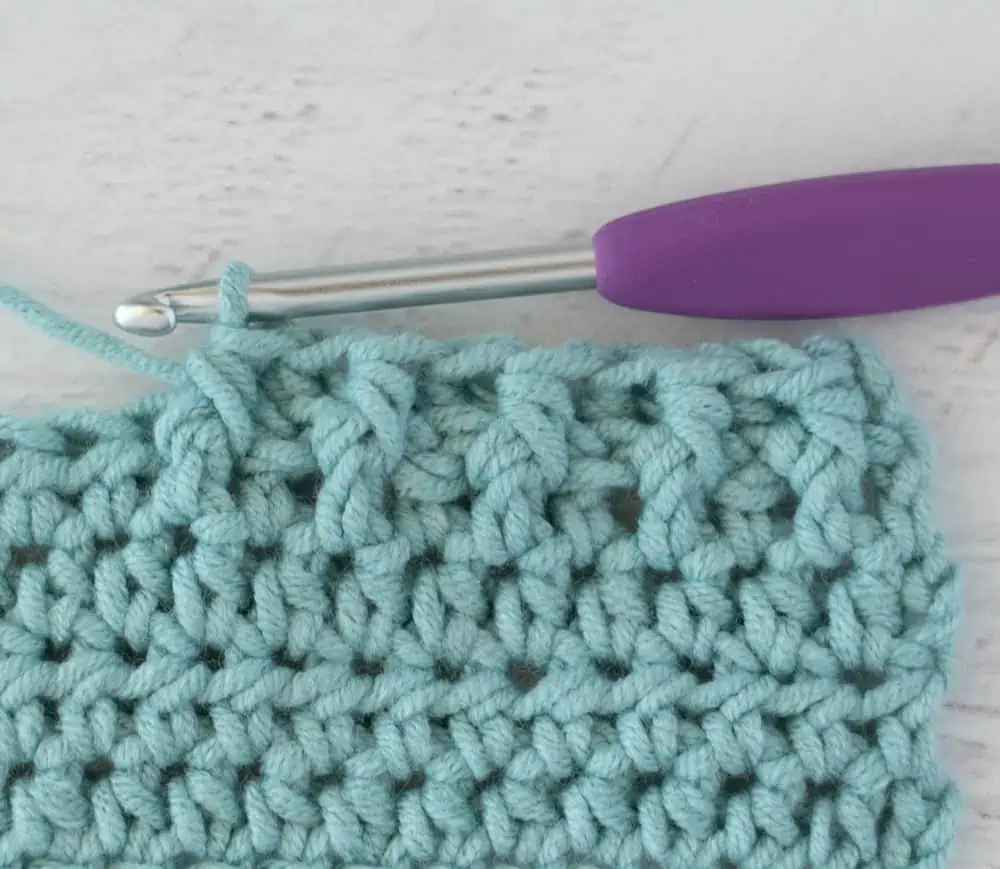 blue crochet half double crochet sample with silver and purple crochet hook