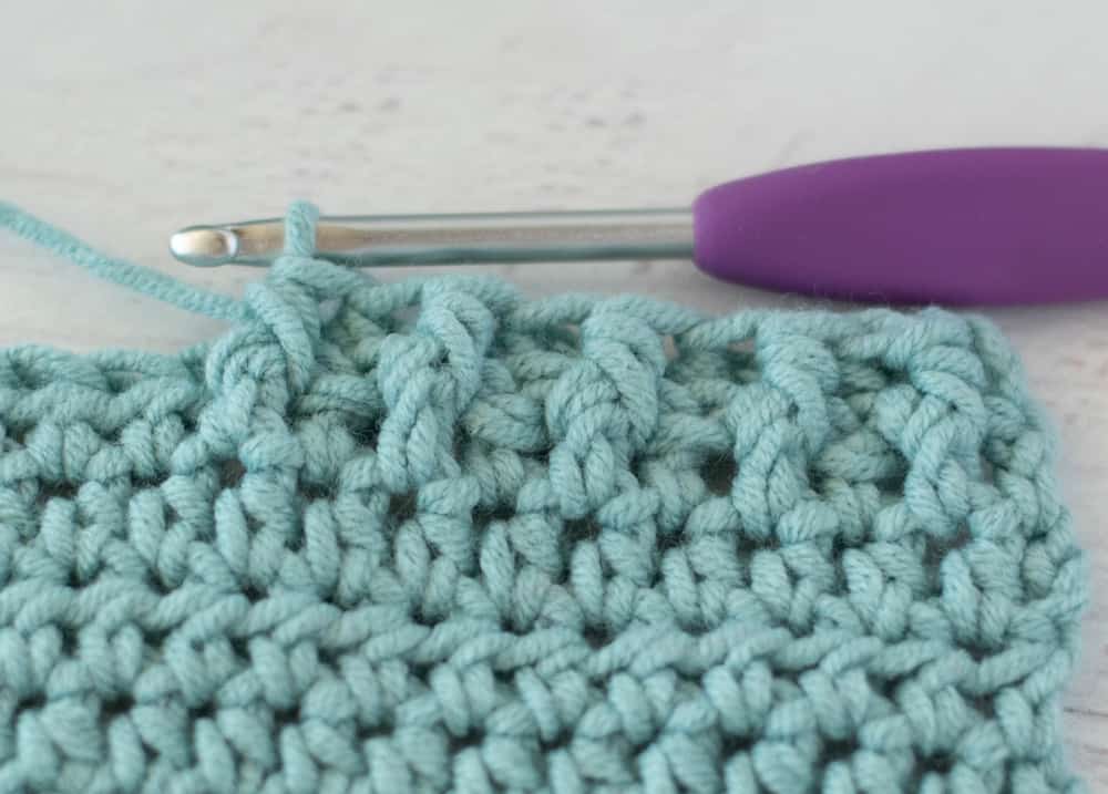 blue crochet half double crochet sample with silver and purple crochet hook
