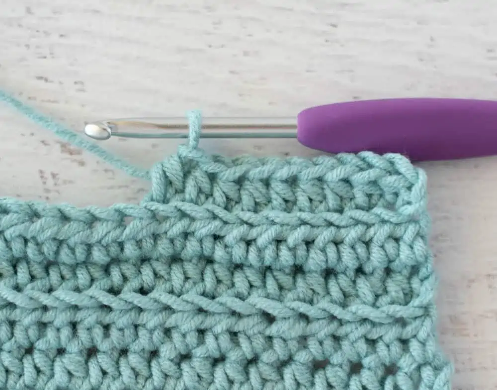 blue crochet half double crochet sample with silver and purple crochet hook