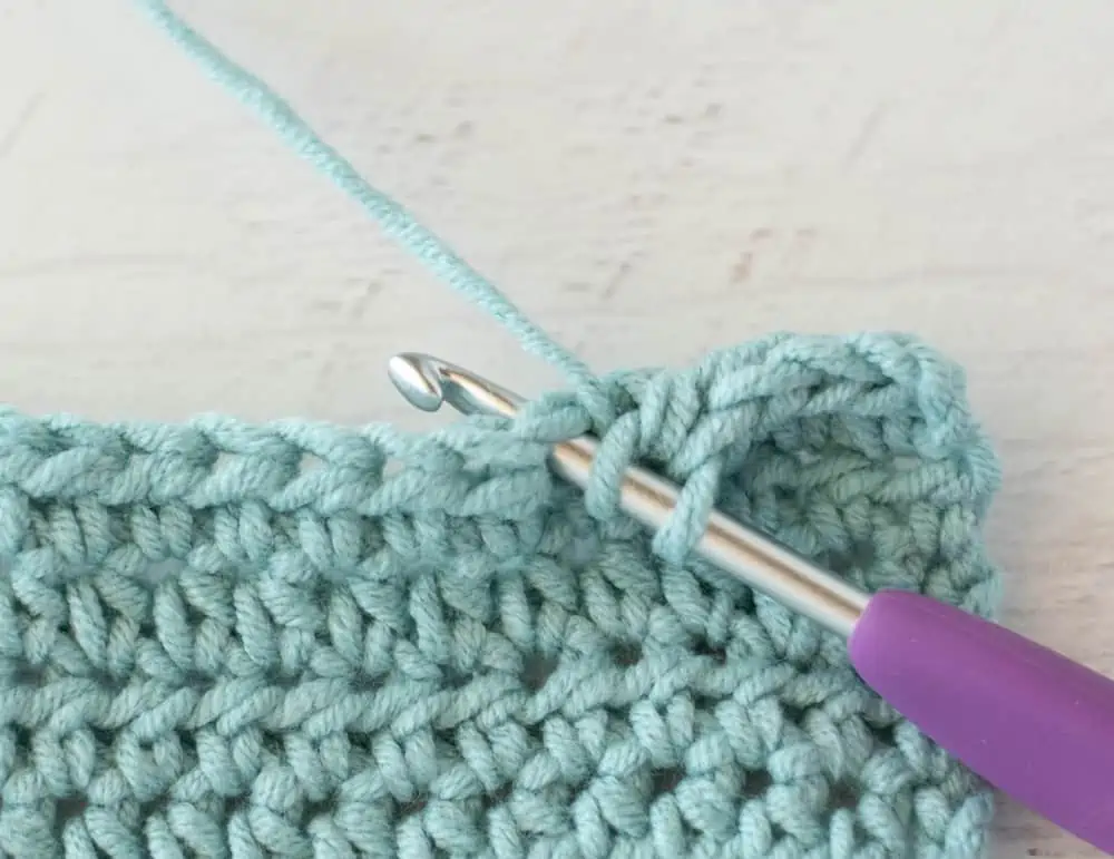 blue crochet half double crochet sample with silver and purple crochet hook