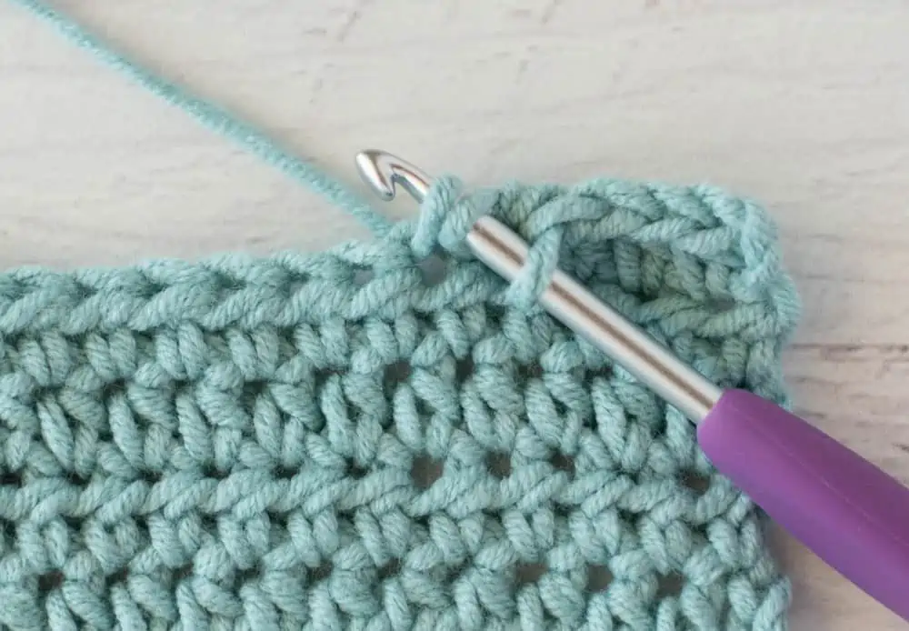 blue crochet half double crochet sample with silver and purple crochet hook