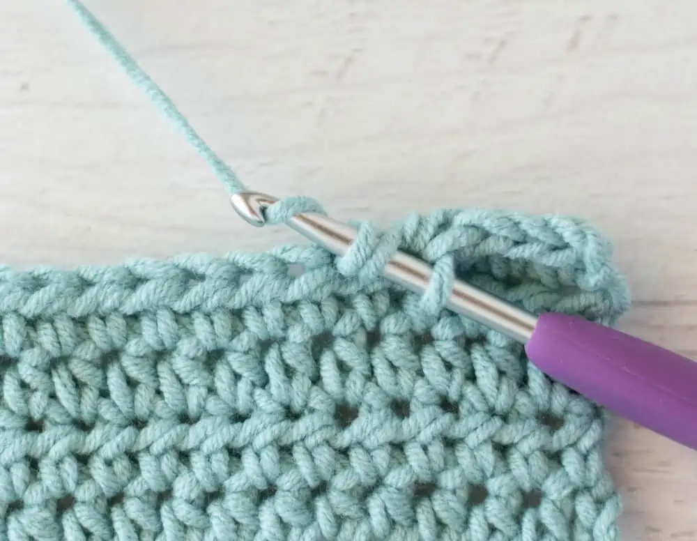 blue crochet half double crochet sample with silver and purple crochet hook