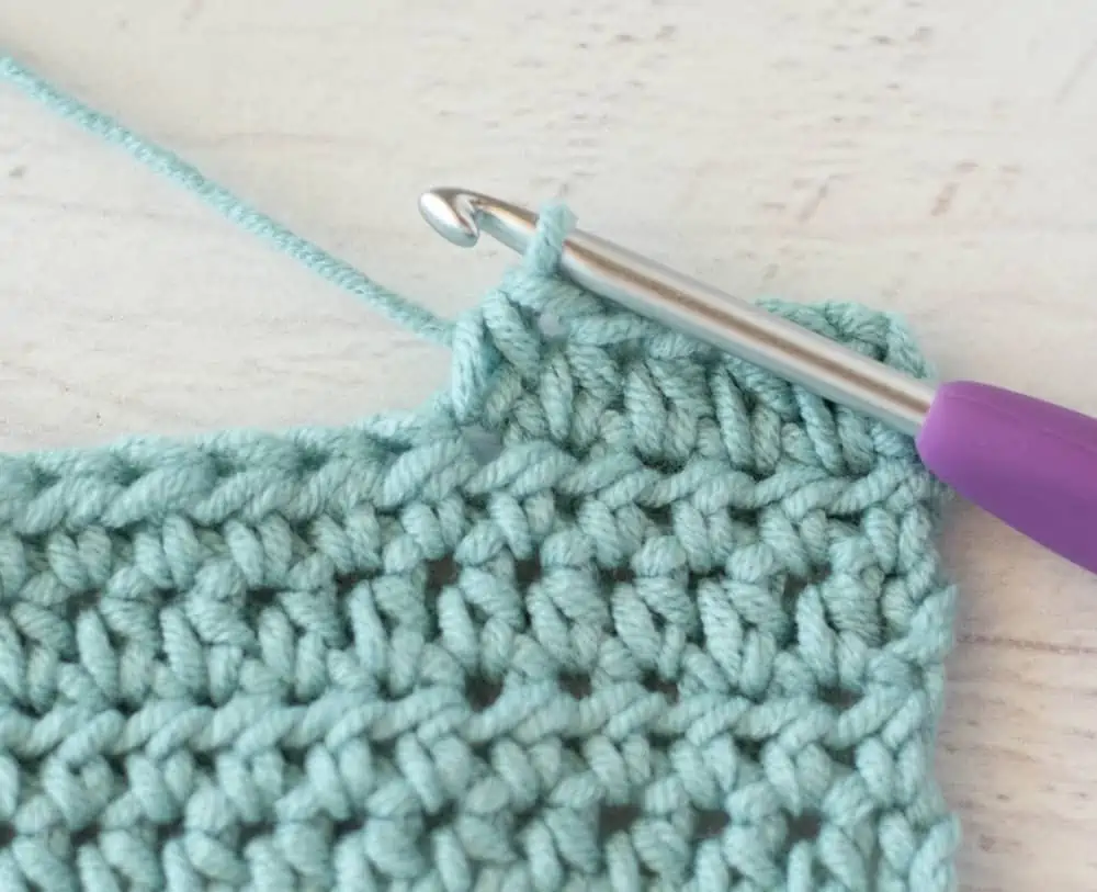 blue crochet half double crochet sample with silver and purple crochet hook