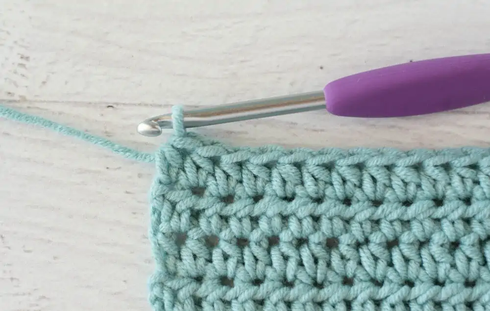 blue crochet half double crochet sample with silver and purple crochet hook