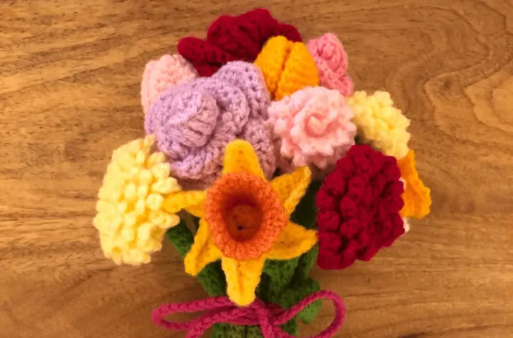 A variety of different crochet flowers in a bundle