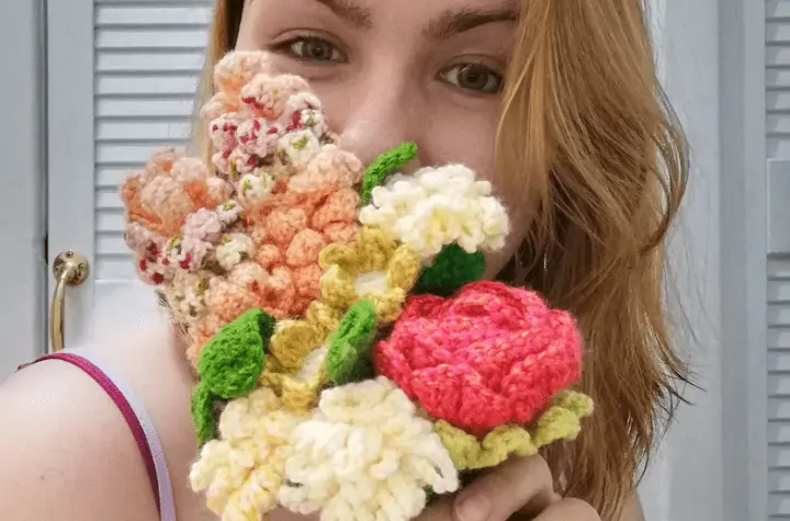 Girl holding a bundle of crochet flowers