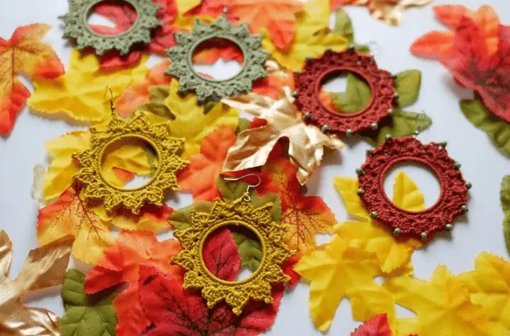 Crochet hoop inspired earings that look like small suns.