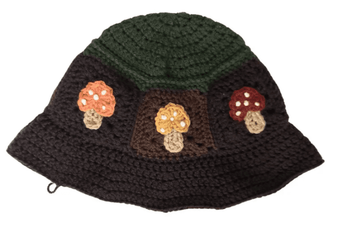 Brown crochet mushroom bucket hat with a green top.