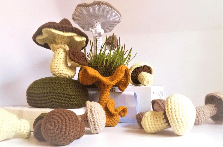 Collection of crochet mushrooms in different colors.