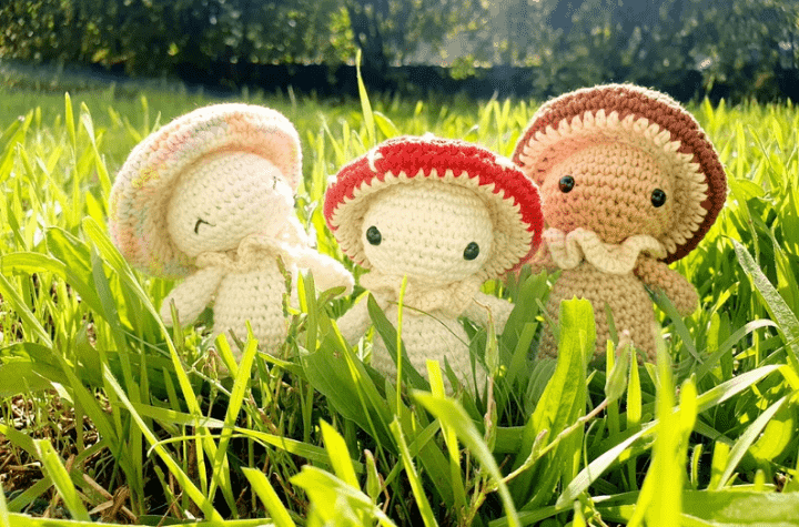 Three amigurumis with little mushroom hats.