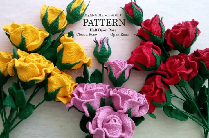 Pink, yellow, and red crochet roses in multiple stages of bloom