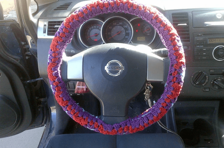 Floral; crochet steering wheel cover using orange and purple yarn