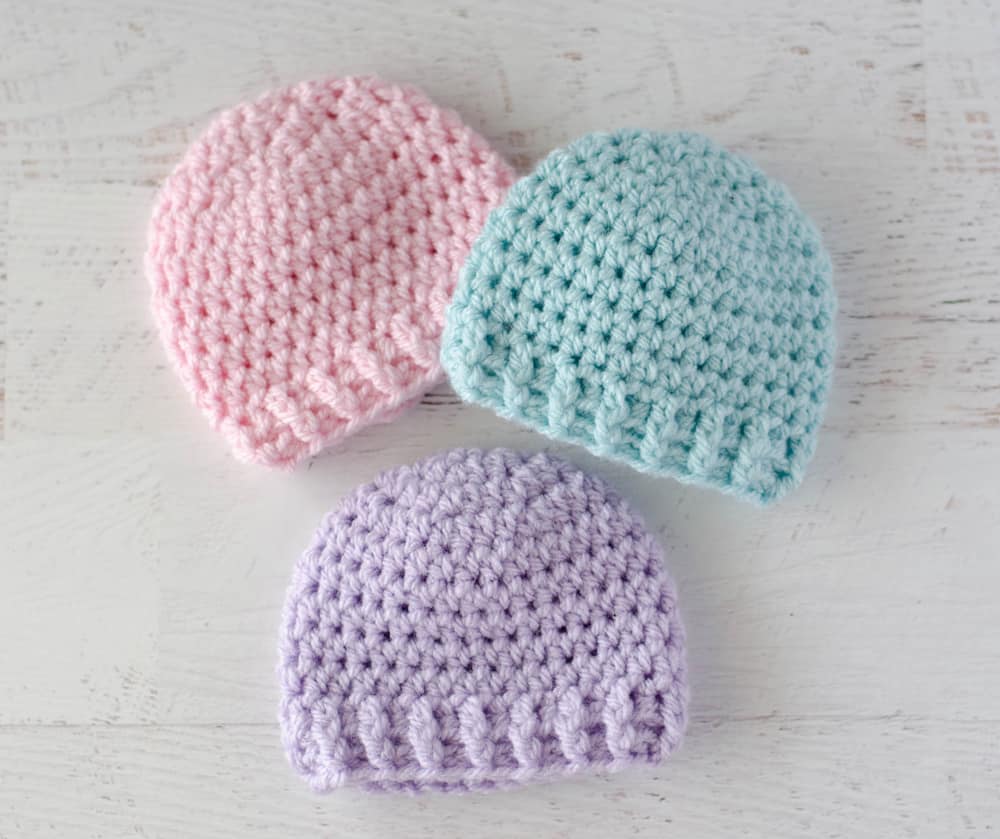 pink, blue and purple crochet baby hats