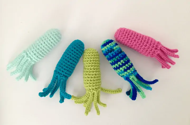 Five crochet squid toys.