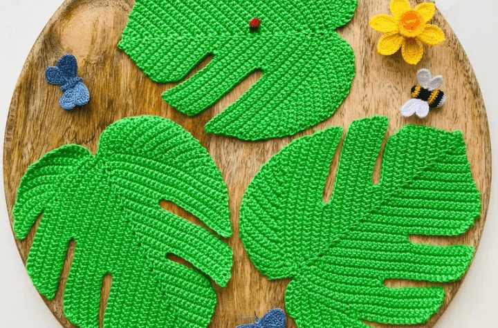 three large crochet monstera leaves.