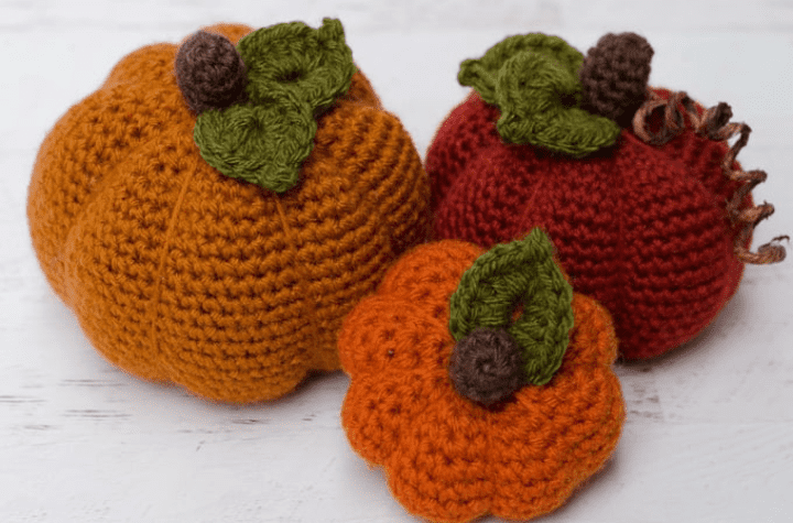 Three different sized crochet pumpkins.