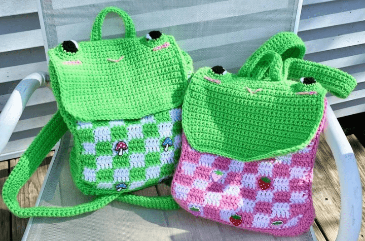 Two frog crochet backpacks.