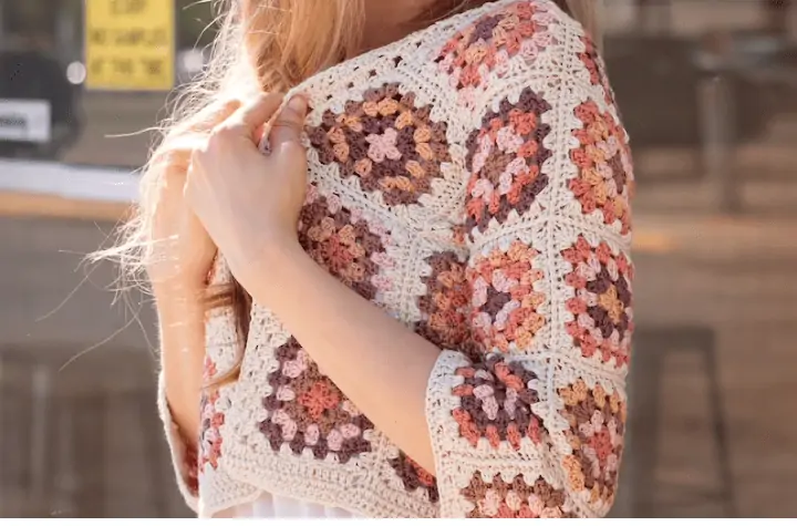 Cropped cardigan featuring nutral colored yarn
