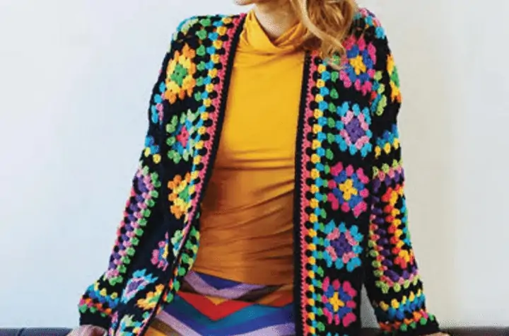 Long granny square cardigan that is mostly black with bright colored granny squares.