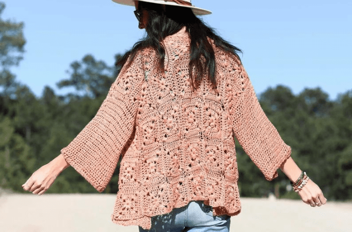 Neutral-colored cardigan with wide sleeves.