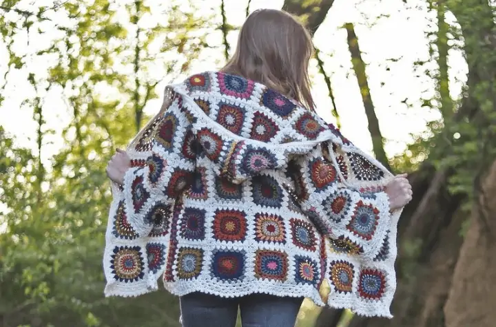 White cardigan featuring bright colored granny squares.