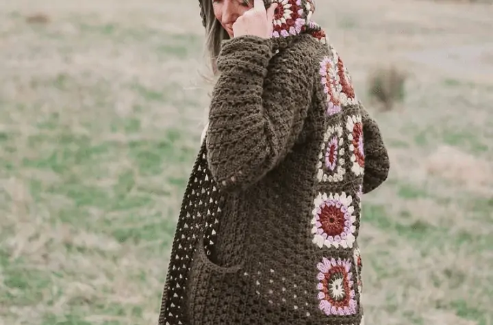 dark green cardigan featuring granny squares along the back.