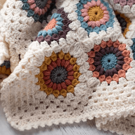 Off white granny style afghan with muted colors