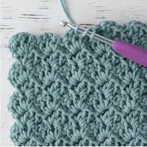 blue crochet sample with purple crochet hook