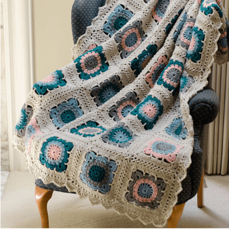 multi color crochet afghan on blue chair