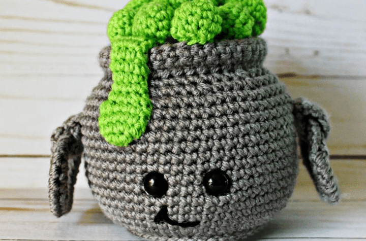 Stuffed crocheted witch cauldron with green ooze.