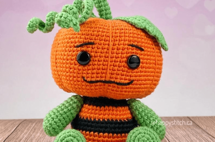 A pumpkin doll, shaped like a teddy bear.