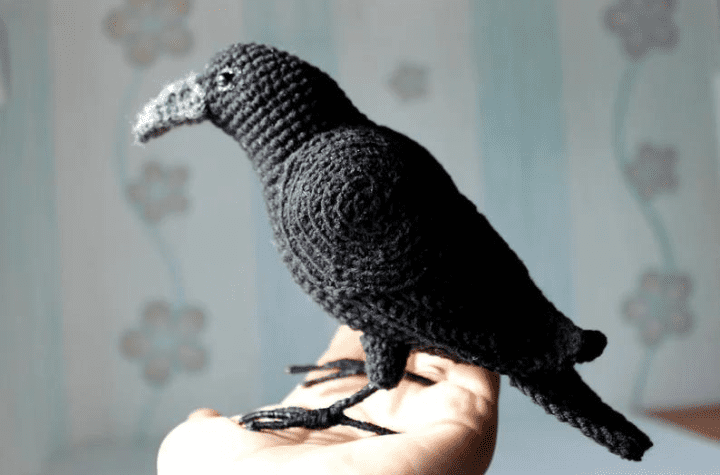 A realistic-looking crochet crow.